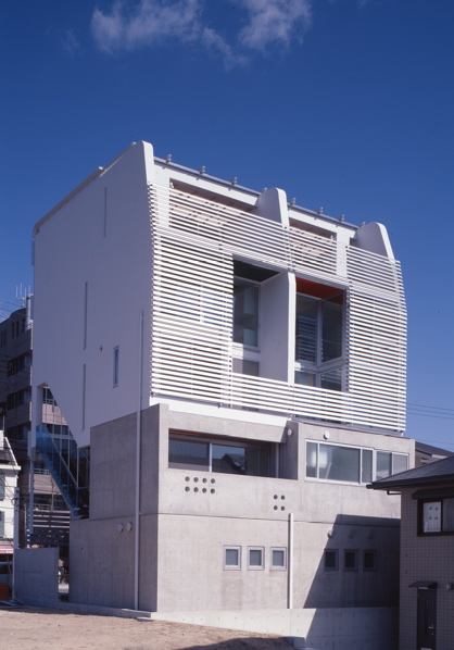 4 in 1 - Concordia Ashiya 4 in 1 is a small-scale apartment house, which incorporates three residential units and a shop unit. The structural system consists of thin RC wall, culvert system floors and the shear resistance internal walls wherever the layout requires. This system allows freedom in layout and ensures the structural stability. The building is fully glazed on the north and south side to provide views of sea and mountains, while east and west side is enclosed considering the possibility of future construction in adjacent currently empty plot. The external skin of this building is composed of soundproof glass wall, roof and the louvers wrapped around the building. <br />(Osaka Governor's Prize at Osaka Architecture Competition)<br />