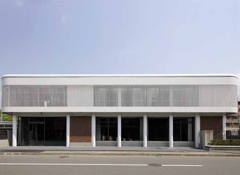 Kyoto Institute of Technology '60th Anniversary Hall' The ‘60th Memorial Hall stands symbolically before the main entrance of the University. The building is located along the axis of existing school building, leaving space for existing trees planted along the street. The ground floor consists of the memorial hall, lecture hall and a gallery. The first floor consists of big and small seminar rooms and a foyer. A part of school’s external wall has been removed so that the building could have a direct access from outside and be open to public. <br />I have chosen “time” as the main theme of this memorial hall, and tried to design “a space that captures time, and let us re-cognize the past.” In other words, in architecture, some concept and techniques are inherited from the past while some gets lost. Architecture consists of many aspects such as sensitivity, memory and symbolism. <br />The original school buildings were designed by Seigo Motono and were made of massive reinforced concrete. It was the style that once called “architecture of new generation”. It somewhat reminded me of the transparency of Fagus Factory and Bauhaus building designed by W. Gropius. It was an ideal image of a University of the time and a figure of future design school with countless possibilities for modern design. <br /> They say contemporary architecture is fading. However, works of unknown artisans give life to architecture. As we walk through a building, it stimulates our senses, touches our heart, and gives sense of respect. Great buildings I have encountered till now have always transmitted these kind of feeling directly to my body. This kind of buildings deserves to be left as a heritage. Design process of this building made me caught up in such thought. <br />I deliberately chose details and materials for the new memorial hall and decided to use steel as a “contemporary” material in contrast with old school building designed by Seigo Motono.<br />