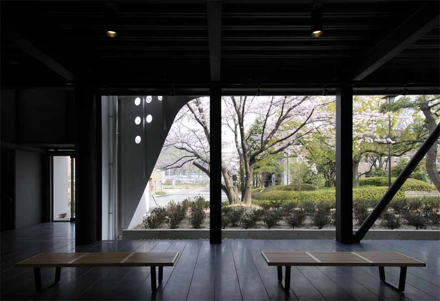 Kyoto Institute of Technology '60th Anniversary Hall' The ‘60th Memorial Hall stands symbolically before the main entrance of the University. The building is located along the axis of existing school building, leaving space for existing trees planted along the street. The ground floor consists of the memorial hall, lecture hall and a gallery. The first floor consists of big and small seminar rooms and a foyer. A part of school’s external wall has been removed so that the building could have a direct access from outside and be open to public. <br />I have chosen “time” as the main theme of this memorial hall, and tried to design “a space that captures time, and let us re-cognize the past.” In other words, in architecture, some concept and techniques are inherited from the past while some gets lost. Architecture consists of many aspects such as sensitivity, memory and symbolism. <br />The original school buildings were designed by Seigo Motono and were made of massive reinforced concrete. It was the style that once called “architecture of new generation”. It somewhat reminded me of the transparency of Fagus Factory and Bauhaus building designed by W. Gropius. It was an ideal image of a University of the time and a figure of future design school with countless possibilities for modern design. <br /> They say contemporary architecture is fading. However, works of unknown artisans give life to architecture. As we walk through a building, it stimulates our senses, touches our heart, and gives sense of respect. Great buildings I have encountered till now have always transmitted these kind of feeling directly to my body. This kind of buildings deserves to be left as a heritage. Design process of this building made me caught up in such thought. <br />I deliberately chose details and materials for the new memorial hall and decided to use steel as a “contemporary” material in contrast with old school building designed by Seigo Motono.<br />